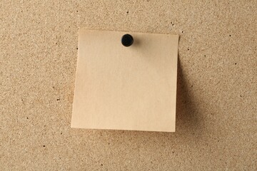 Blank note pinned on cork board, space for text