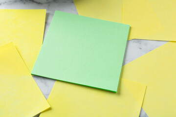 Blank notes on white marble table, closeup. Space for text