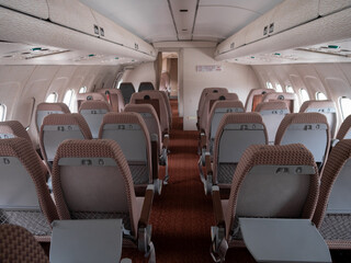 Fototapeta premium airplane interior scene, symmetrical airplane cabin layout with ambiance and seating, interior of airplane showing economy class with symmetrical seating arrangement and lighting ambiance