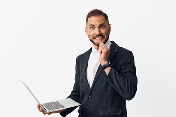 A confident business professional man on an isolated colored background, expressing thoughtful...