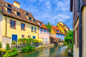 River Lauch canal with old colorful houses medieval buildings in Little Venice la Petite Venise area in old town Colmar city historic centre in sunny summer day, Alsace Grand Est region, France