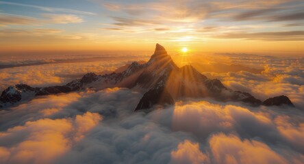 Fototapeta premium A dramatic, sunlit mountain peak pierces through a sea of clouds during a fiery sunrise