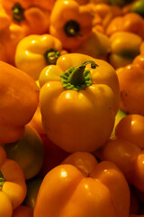 Fresh yellow bell peppers close-up at grocery market