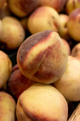 Fresh white peaches with red blush at grocery market