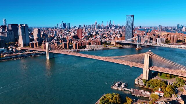 View on the Manhattan Bridge and Brooklyn Bridge from Brooklyn. Downtown of New York at backdrop on sunny day.