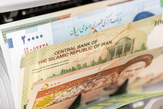 Iran money, Machine counting Iranian rial banknotes. Financial background, business concept, close up