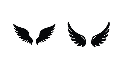 Fototapeta premium Two sets of black feathered wings isolated on a symbolizing freedom and angelic imagery.