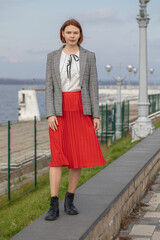 Obraz premium Fashion portrait of a young beautiful woman in red skirt