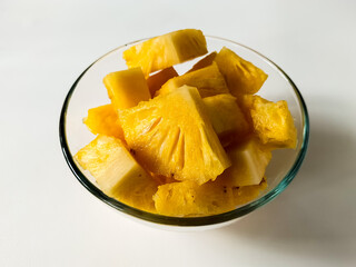 A vintage camera sits on a light surface, illuminated by soft natural light creating shadows. 