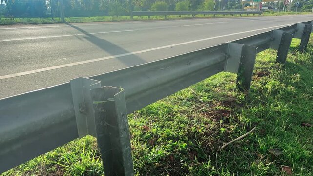 The guard rail, barrier on wayside with cloudy and hill. the straight line from highway fence. image from background, highway fence