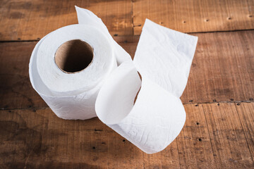 Worn toilet paper on an old wooden table
