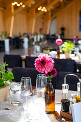 Elegant Wedding Reception Hall with Floral and Green Table Decorations
