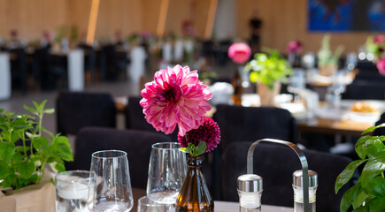Elegant Wedding Reception Hall with Floral and Green Table Decorations