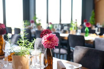 Elegant Wedding Reception Hall with Floral and Green Table Decorations