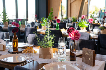 Elegant Wedding Reception Hall with Floral and Green Table Decorations