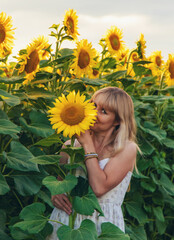 Woman in sunflowers in a field. Selective focus. © yanadjan