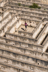 Woman standing in the monumental stone walls of Lithica, Pedreres de s'Hostal, in Menorca, Spain.