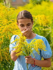 Child in ragweed flowers allergy. Selective focus.