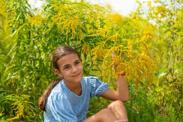 Child in ragweed flowers allergy. Selective focus.