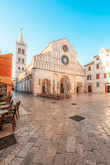 Fototapeta premium Zadar, Croatia. Old town street of Zadar with the Church of St. Donatus and the bell tower of the Cathedral of St. Anastasia at sunset.