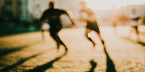 Figures running on the field, sports, soccer or football, out of focus, blurred and out of focus