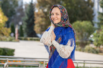 Portrait of a young beautiful woman with a scarf on her head