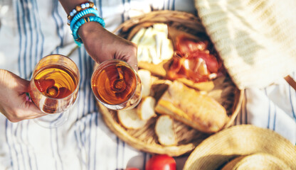 Wine in hands of woman at picnic. Selective focus. © yanadjan