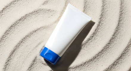 Top view of sunscreen tube on light sand-textured background, bright lighting, summery feel, skincare concept for UV protection and daily routine.