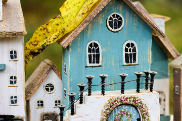 Detailed macro shot showcasing a group of delightful miniature wooden fairy houses, highlighting...