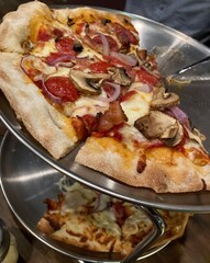 two pizzas on stand