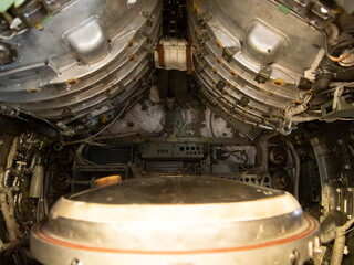 rusty turbine area, corroded turbine chamber featuring tangled wiring and rust accumulation, rusty turbine engine area showing corrosion and chaotic wiring in compartment surroundings