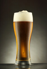 a glass mug with beer in drops