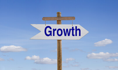 White wooden arrow with the inscription: Growth