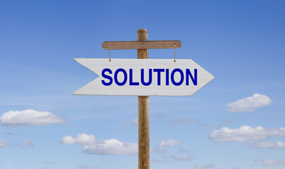 White wooden arrow with the inscription: Solution