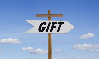 White wooden arrow with the inscription: Gift