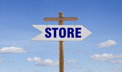 White wooden arrow with the inscription: Store