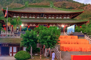 Obraz premium A traditional stone bridge with red lanterns in Nianshan Park, Sanya, Hainan, China.