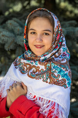 Portrait of a young beautiful woman with a scarf on her head