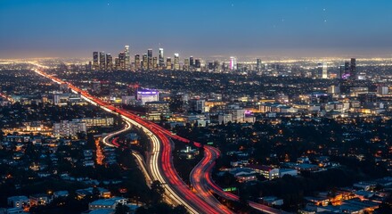Obraz premium Los Angeles cityscape at twilight with illuminated highways and downtown skyline, urban sprawl with light trails creating dynamic night scene