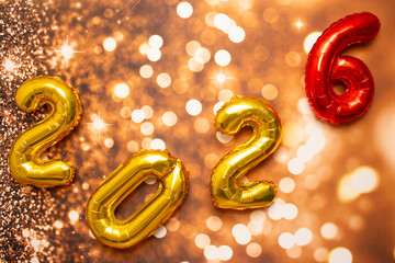 golden sign saying 2026 with bokeh background