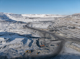 Winter view of open pit coal mine with clear blue sky