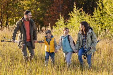 Family enjoys hiking together in a serene nature in autumn