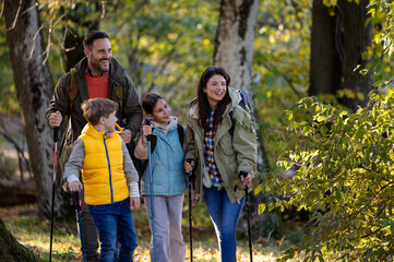 Family enjoys hiking together in a serene forest in autumn