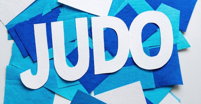 Judo word displayed using paper cutouts. Blue tones dominate background, creating dynamic visual effect. Simple, bold typography.