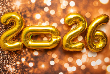 golden sign saying 2026 with bokeh background