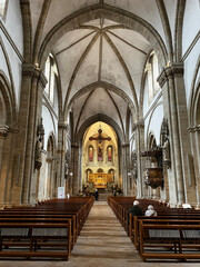 The photo shows the grand altar of Osnabruk’s Romanesque cathedral, featuring high vaulted...