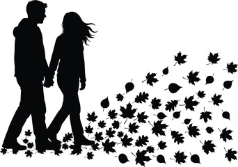 Silhouettes of a couple holding hands walking through falling autumn leaves