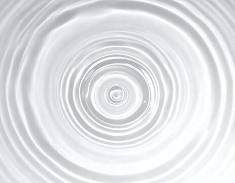 Abstract close-up of concentric water ripples radiating outwards from a central point, creating a mesmerizing circular pattern.