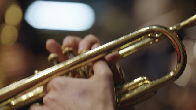 Close-Up of Hands Playing Trumpet at Live Concert