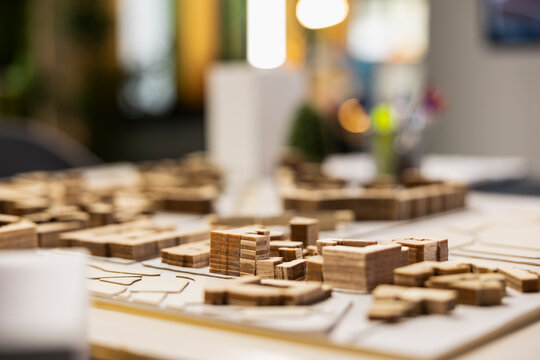 Quiet empty office space in a modern real estate development firm shows 3D models urban layout on table, architecture design tools used in housing and redevelopment planning. Master plan.